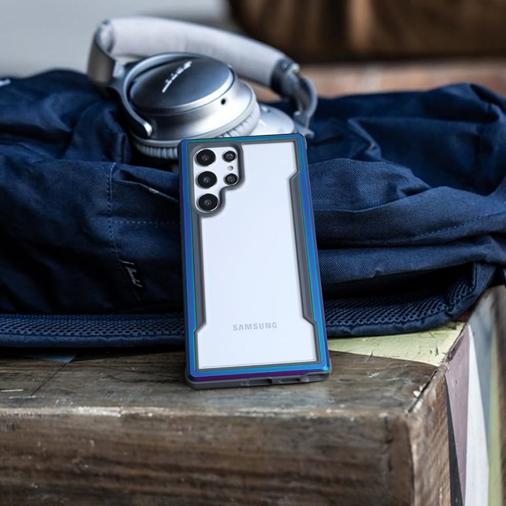 A samsung galaxy s10e with headphones on top of a wooden table.