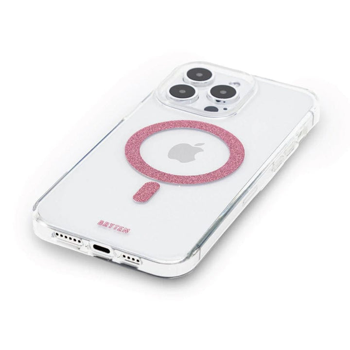 The Bryten by Raptic iPhone 15 MagFx MagSafe Case encases a white smartphone with three camera lenses, providing clear protection against drops. The back of the phone showcases a pink glittery circular design and supports wireless charging, ensuring compatibility with the MagSafe charger.
