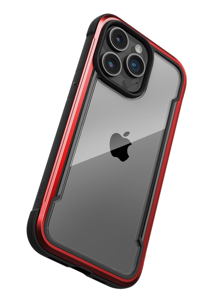 A smartphone in a clear, rugged Raptic Shield iPhone 15 Shield Case with a red border. Adhering to MIL-STD-810G Standards, it features a dual-lens camera and an Apple logo on the back. Enjoy up to 3-metre drop protection for ultimate peace of mind.