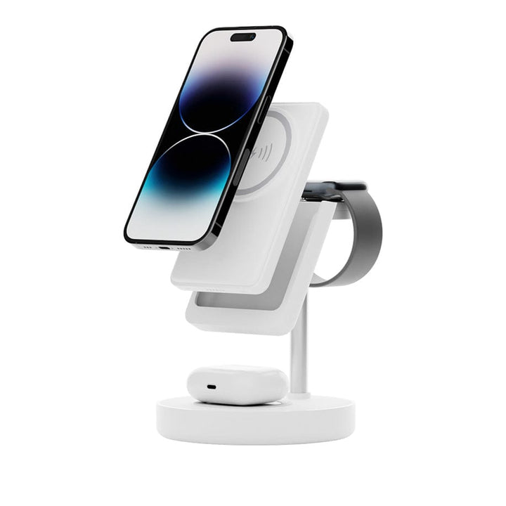 Presenting the Urban 6-in-1 MagSafe M6 Wireless Charger Station by Urban: a sleek, white, multi-functional stand that effortlessly charges your smartphone, smartwatch, and wireless earbuds. The smartphone is displayed vertically, secured with iPhone-compatible magnetic cases. The smartwatch loops around a circular holder on the side of the stand, while the earbuds rest comfortably on a charging pad at the base.