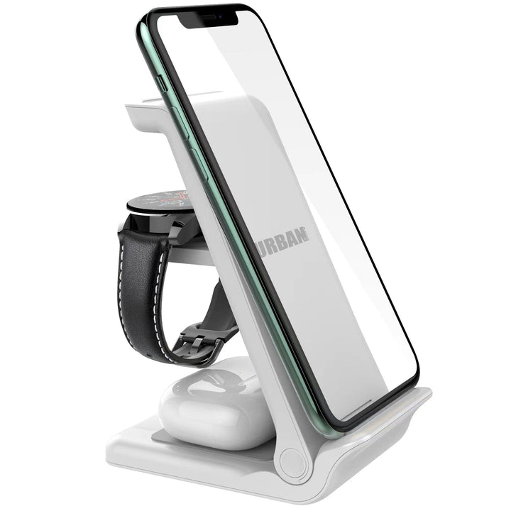 The Urban Travel S 3 in 1 Wireless Charger by Urban, a white charging stand, is perfect for holding a smartphone, a smartwatch, and wireless earbuds.