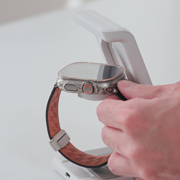 A person places a smartwatch on the sleek Urban Travel S 3 in 1 Wireless Charger, perfectly complementing their tech-savvy lifestyle.