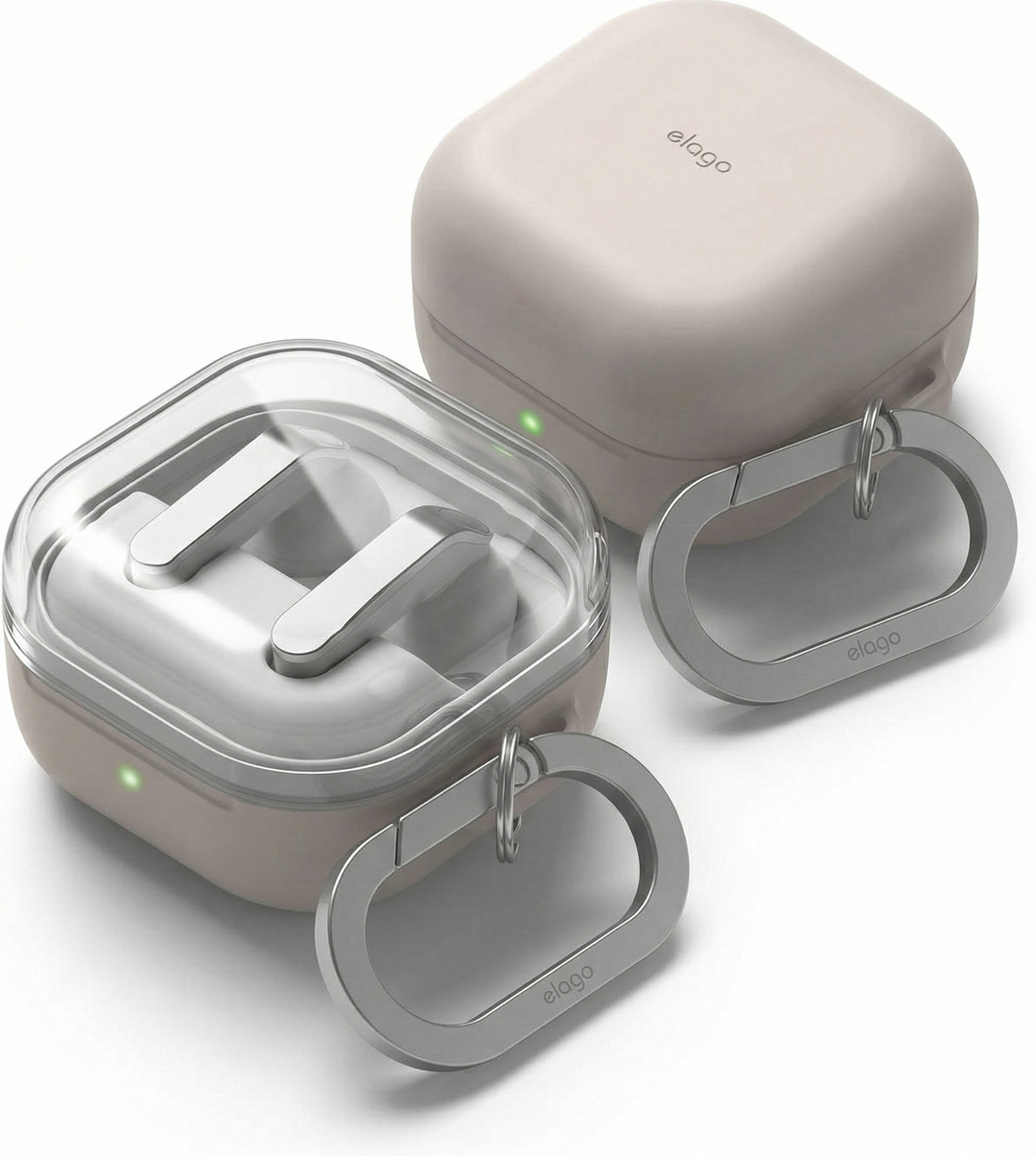 Two beige Elago AirPods cases with metal carabiner keychains are shown, one open revealing AirPods inside with a clear lid, and one closed; both have small green LED lights.