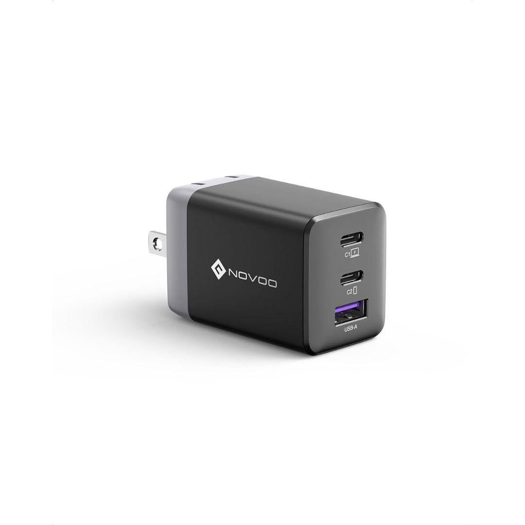 The Novoo 67W GaN iii Wall Charger is a black, rectangular USB-C wall charger with two USB-C ports and one USB-A port, featuring fast charging for multiple devices. It has a silver plug, NOVOO logo on the side, and sits on a plain white background.