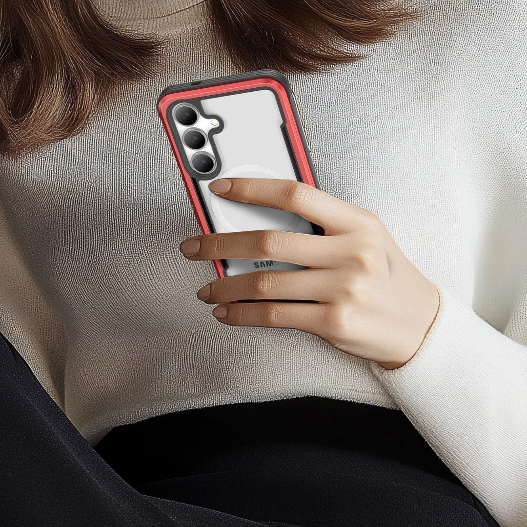 A person in a white sweater holds a Samsung S25, fitted with a Raptic Shield case, in their right hand. The image focuses on the phone and its red-clear case, highlighting its military-grade protection and shock absorption against a soft-focus view of their upper body.