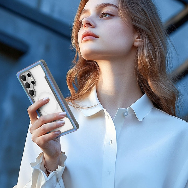 A person with long hair in a white blouse holds a smartphone featuring multiple camera lenses. The phone, encased in a sleek Samsung S25 Shield Case by Raptic, offers military-grade protection. Outdoors against a blurred industrial backdrop, they gaze skyward.