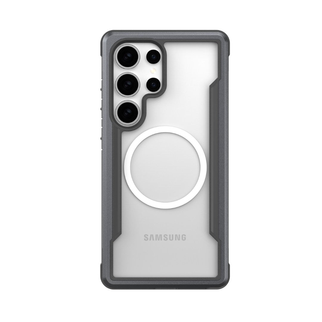 The Raptic Samsung S25 Shield Case is a rugged transparent case with a MagSafe-compatible magnet, offering military-grade protection. It features dark gray reinforced edges, shock-absorbing bumpers, multiple lens and flash cutouts. The "Samsung" brand is visible on the case.