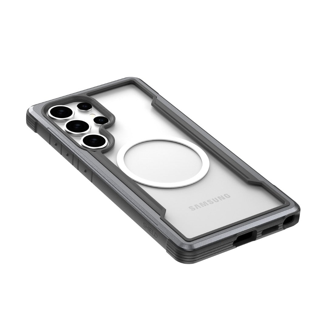 The Raptic Samsung S25 Shield Case combines style and durability, featuring a transparent back, prominent circular MagSafe ring, precise openings for lenses and buttons, reinforced military-grade edges, and a visible Samsung logo. Available in sleek grey.