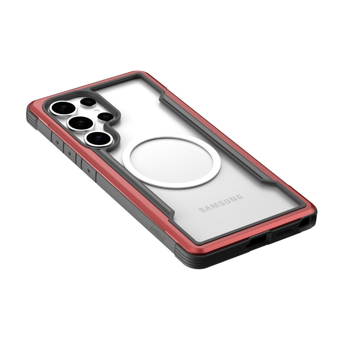 The Raptic Shield Samsung S25 case features a clear polycarbonate back with red edges, providing military-grade protection. It includes precise cutouts for the quad-camera and flash, with accessible side buttons. A circular design on the back suggests possible MagSafe compatibility.