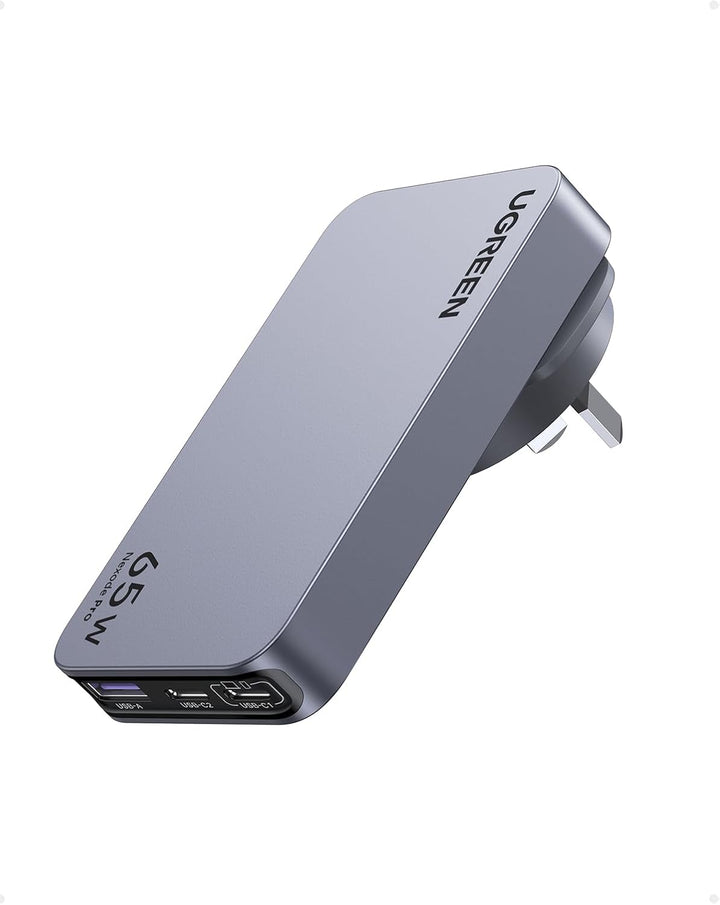 The image shows a sleek gray UGREEN 65W Nexode Pro Ultra-Slim Travel Charger with foldable UK plug. Featuring three ports (USB-C and USB-A), it’s compatible with iPhone, MacBook, Galaxy, Pixel, and more. "UGREEN" is branded on top.
