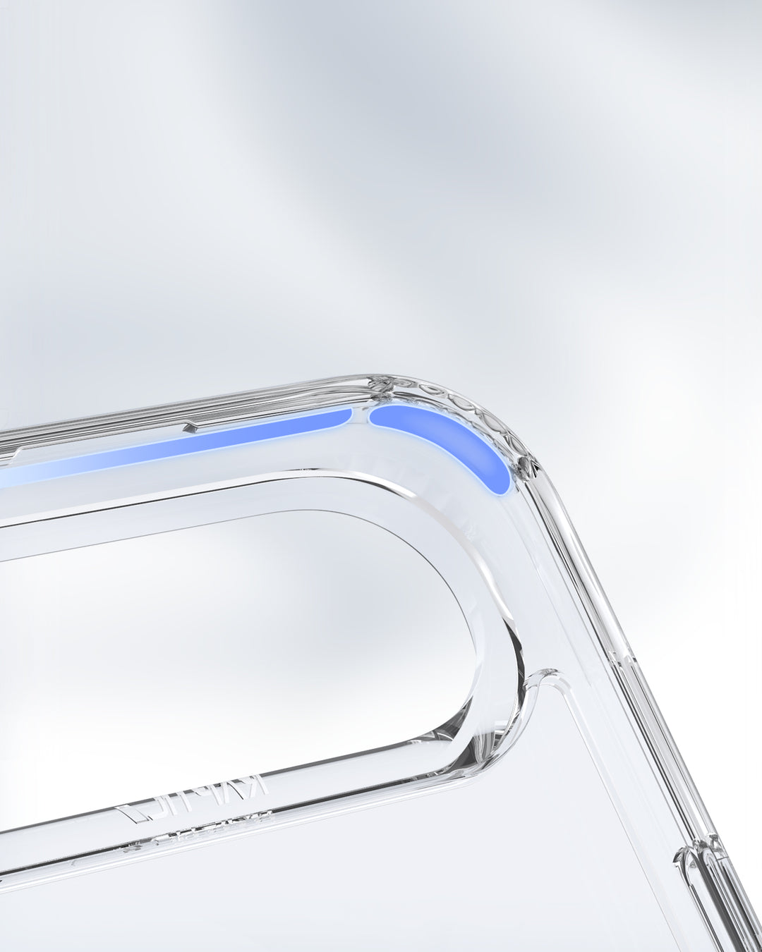Close-up of the Raptic iPhone 17 Magnetic Kickstand Case - Air Stand shows soft blue accents on the corner. The transparent MagSafe-ready case features smooth, rounded edges, a camera cutout, and a blurred gray-white background.