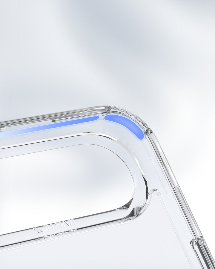 Close-up of the Raptic iPhone 17 Magnetic Kickstand Case - Air Stand shows soft blue accents on the corner. The transparent MagSafe-ready case features smooth, rounded edges, a camera cutout, and a blurred gray-white background.
