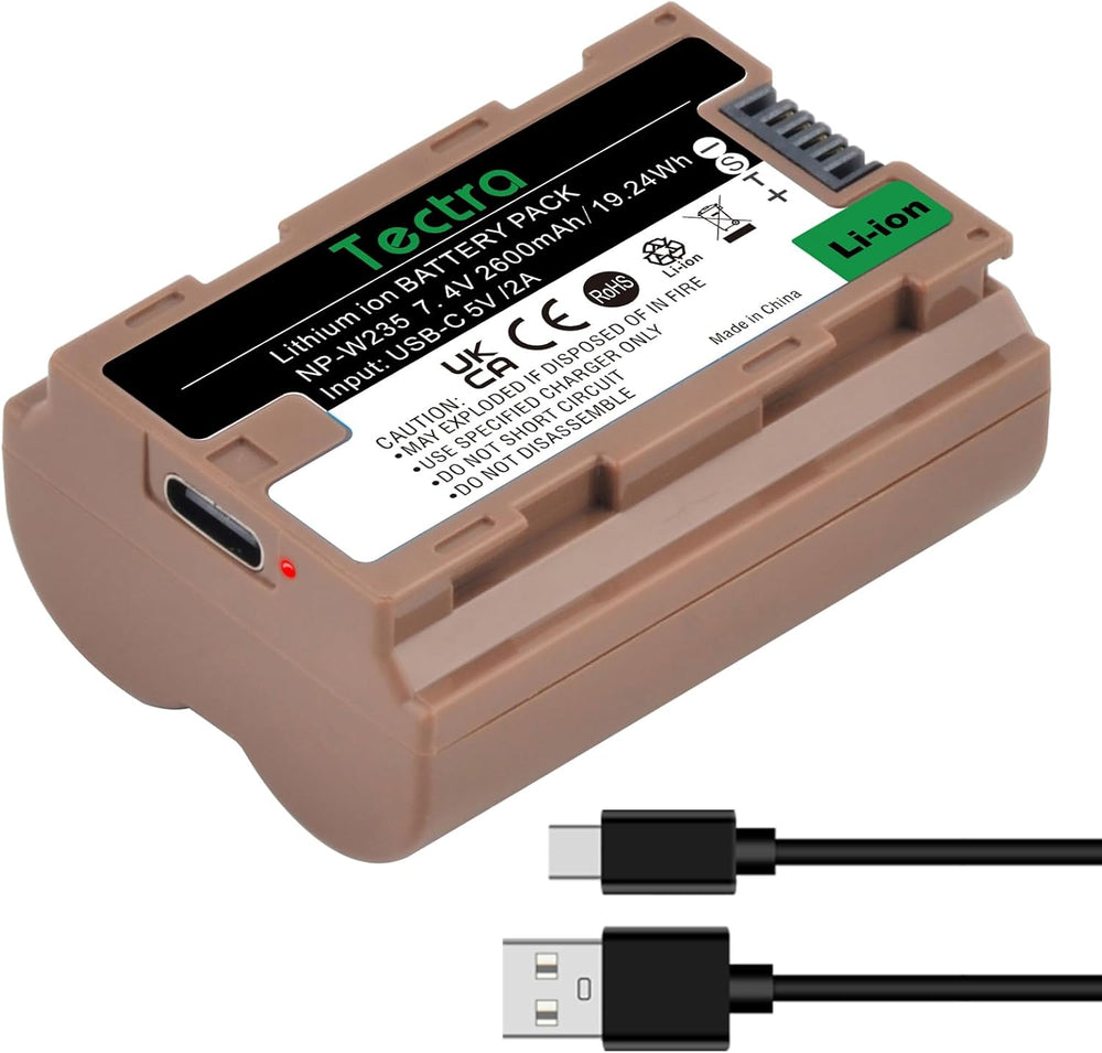A MobileTechnica Tectra NP-W235 brown lithium-ion battery for Fujifilm cameras, showing specs and safety info on its label, rests on a premium wrapper. Below it lies a black USB-A to USB-C cable for fast charging.