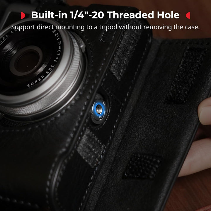 Close-up of the SMALLRIG Leather Case Kit for FUJIFILM X100VI by MobileTechnica in black, showing a blue 1/4"-20 threaded hole for direct tripod mounting. Text: "Built-in 1/4''-20 Threaded Hole—mount without removing the case.