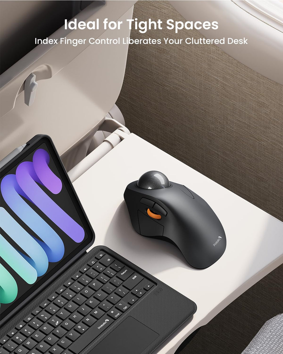 A MobileTechnica ProtoArc Wireless Trackball Mouse (EM03) and a tablet with keyboard sit on a small airplane tray table, showcasing how the ergonomic Bluetooth mouse saves space. Text: “Ideal for Tight Spaces. Index Finger Control Liberates Your Cluttered Desk.”.