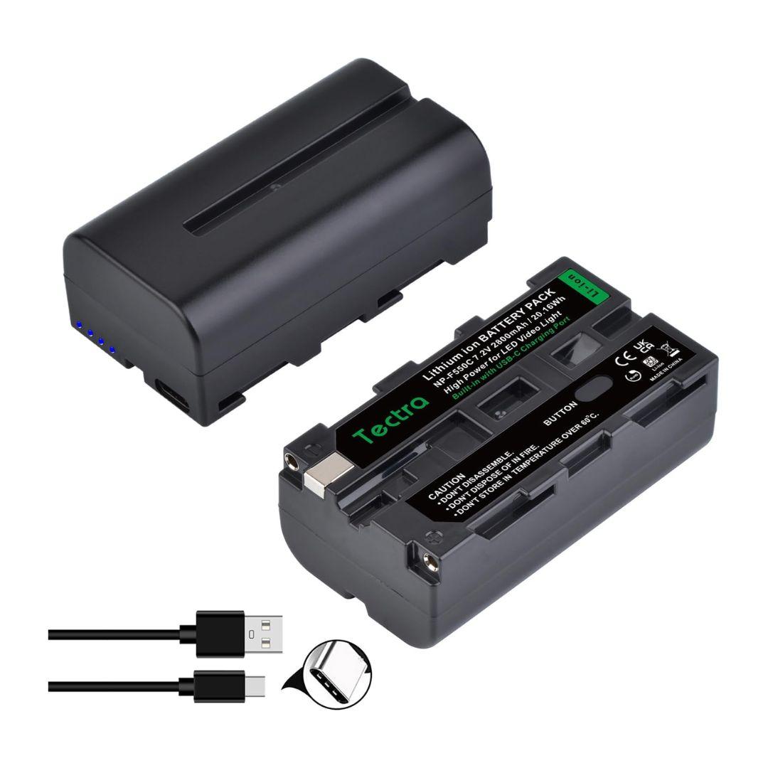 A MobileTechnica Tectra 2800mAh Battery for Sony NP-F550/F570/F970 is shown from two angles, highlighting a USB-C port and green indicator. This rechargeable lithium-ion 2-pack comes with a matching cable and displays the “no memory effect” icon.