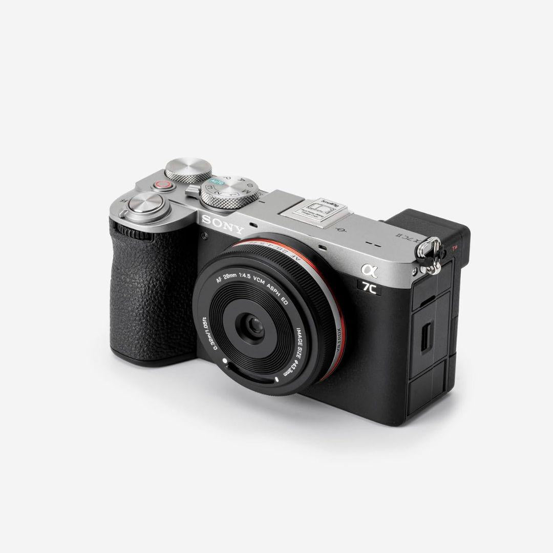 A Sony Alpha 7C mirrorless camera with a black textured grip is shown on white, equipped with a Viltrox 28mm f/4.5 FE wide-angle lens for Sony Full Frame cameras, featuring fast autofocus and multiple top dials and buttons.
