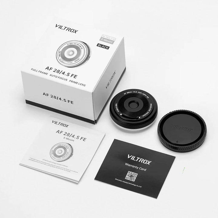 A Viltrox 28mm f/4.5 FE lens kit for Sony Full Frame Cameras is displayed on a white surface, featuring the wide-angle lens, Viltrox-branded rear and front caps, product box, manual, and warranty card arranged in a flat lay.
