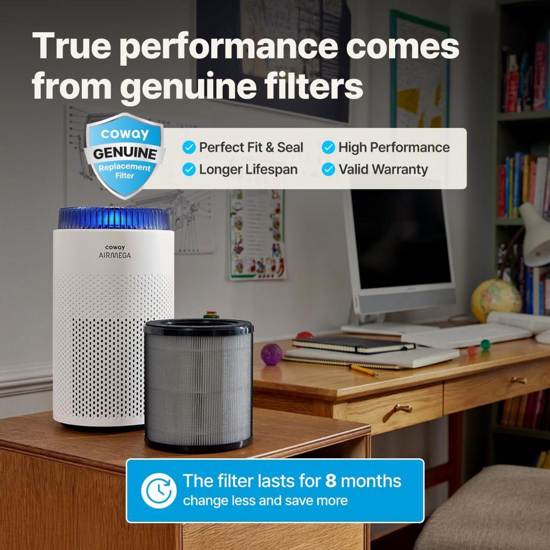 A MobileTechnica Portable Air Purifier - Coway Airmega 50 and two genuine filters sit on a wooden desk in a cozy room. Overlay text notes whisper-quiet operation and “The filter lasts for 8 months.”.