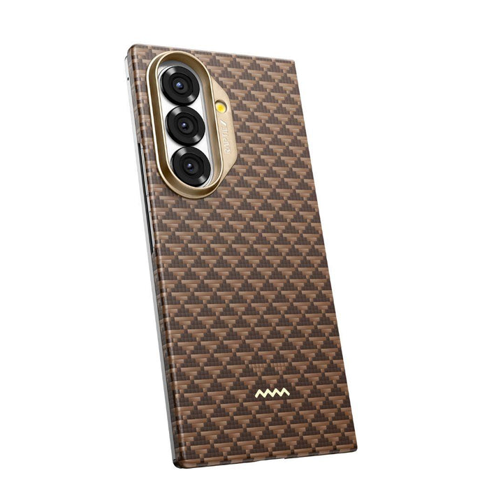 The RAPTIC Samsung Galaxy Fold 7 Skin Case – Humble Desert features brown and black carbon fiber style, gold-trimmed triple camera cutout, a woven pattern, hinge protection, a white logo at the bottom center, and is pictured at an angle.