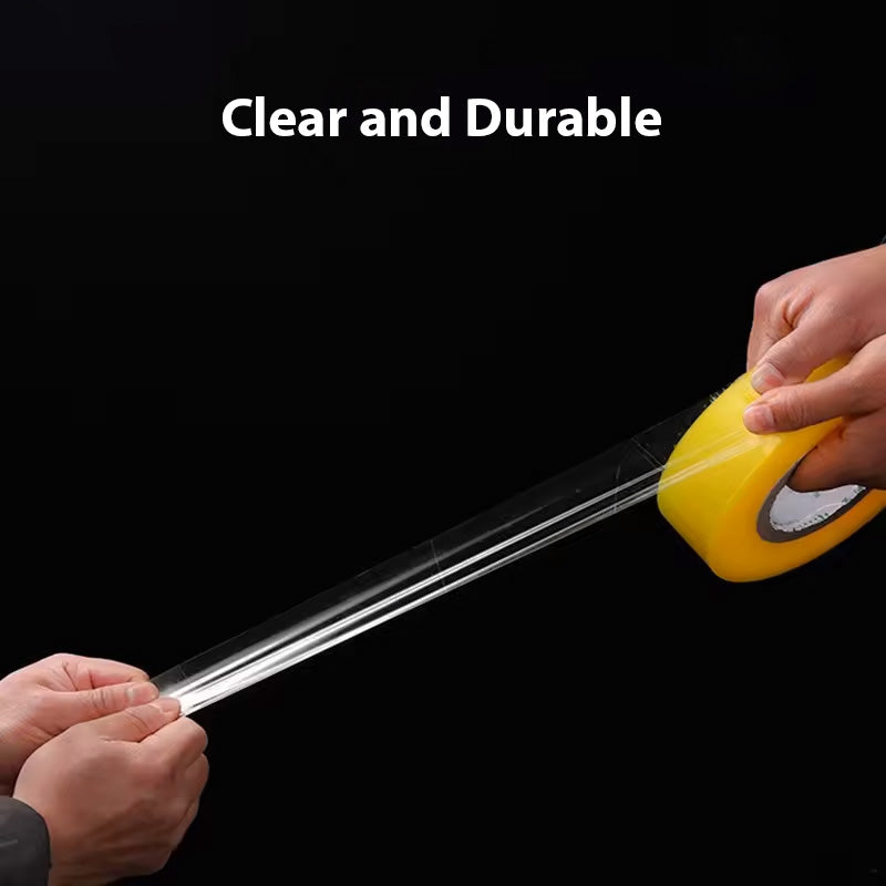 Two hands pull Clear Packaging Tape from a roll with a yellow core against a black background. The phrase "Clear and Durable" in bold white text highlights MobileTechnica's tape transparency and strength, featuring tear-resistant design and strong adhesion, ideal for packaging.