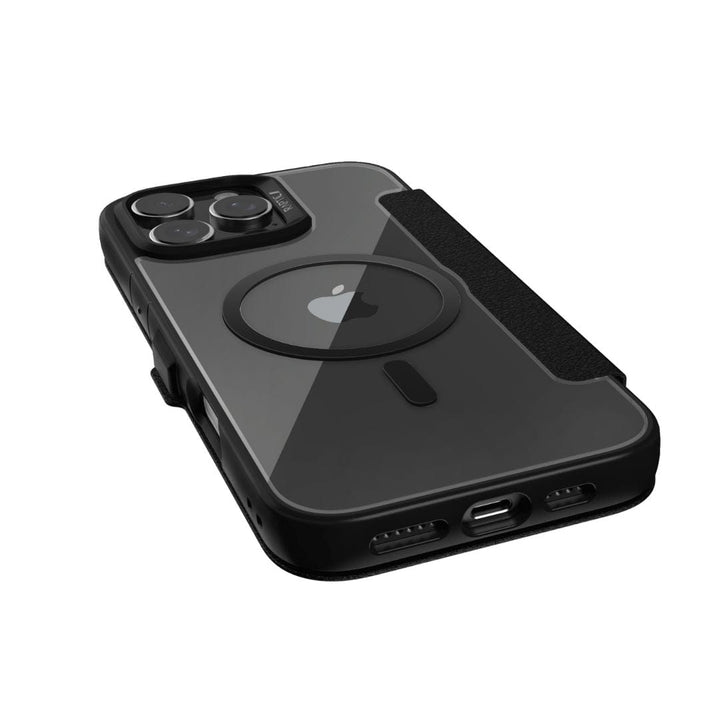 A black iPhone with a transparent Raptic MagSafe Urban Folio Case with Card Slot for iPhone 16 rests on its back, showcasing the Apple logo and the MagSafe ring on the rear. The Raptic case features a built-in kickstand and recessed camera protection. The bottom of the phone displays the charging port and speaker grilles.