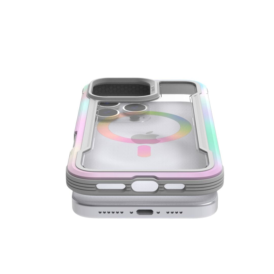 A modern iPhone 16 Pro Max is encased in a transparent, color-accented Raptic Shield 2.0 MagSafe case with TPU bumpers for extra protection. The case, designed by Raptic, features a cutout for the camera that reveals the rear lenses and includes a subtle MagSafe ring. The phone's charging port, speaker grills, and buttons remain visible.
