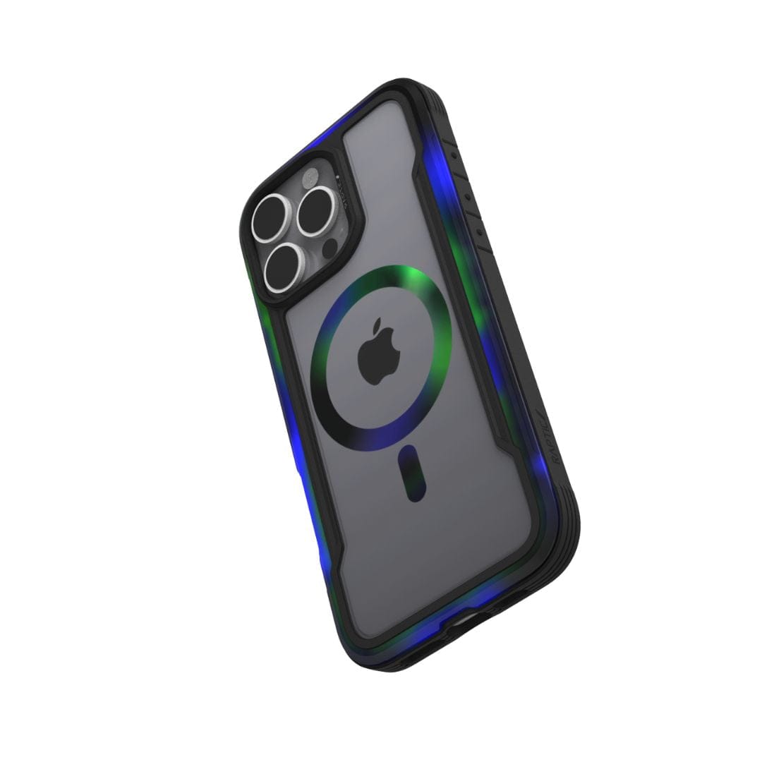 A black smartphone in a transparent Raptic Shield 2.0 MagSafe for iPhone 16 Pro Max case with rugged reinforced corners is shown. The phone's back displays a visible Apple logo and a circular MagSafe ring, while the camera module features a three-lens system and a flashlight. The TPU bumper helps tilt the phone at an angle.