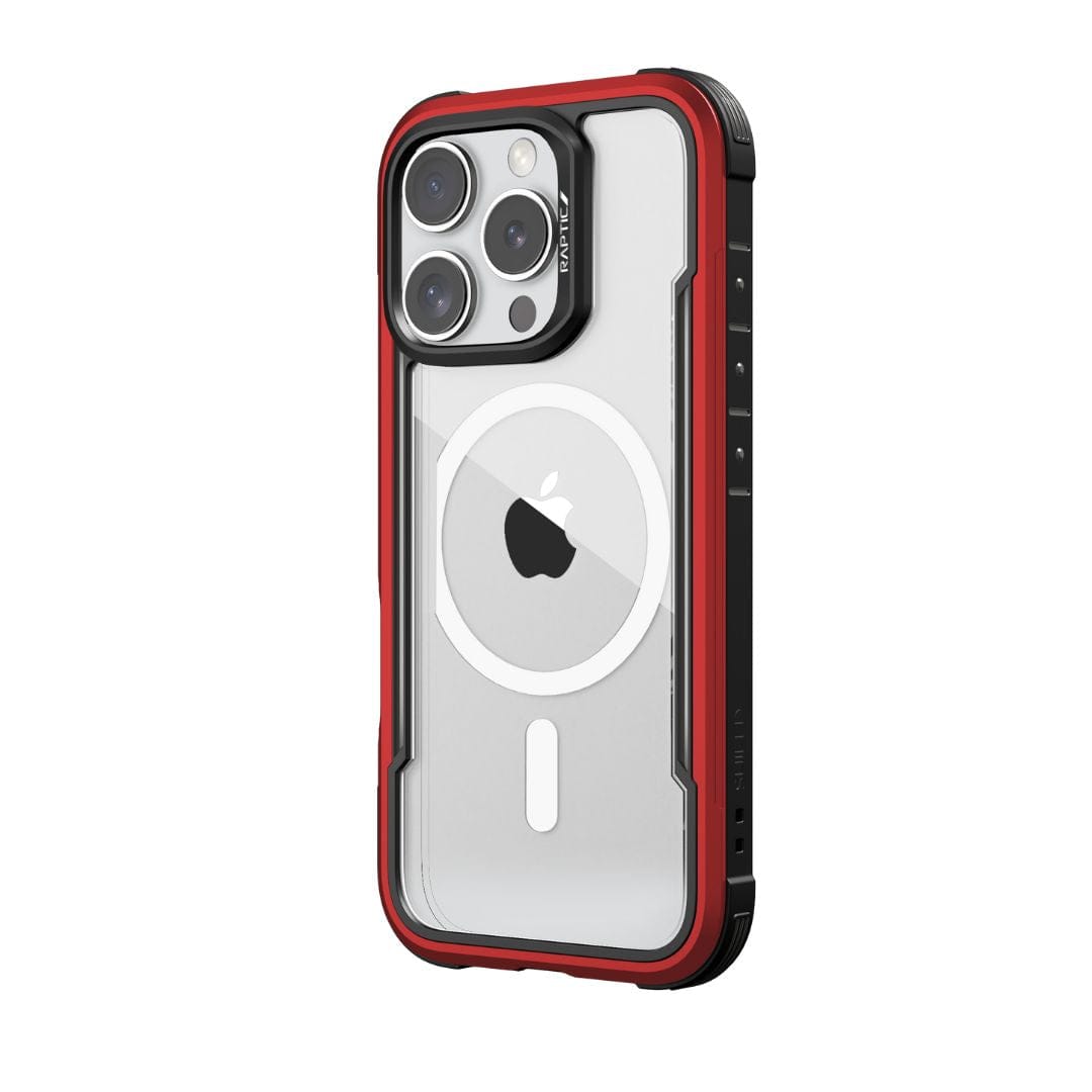 A smartphone, protected by the Raptic Shield MagSafe Case for iPhone 16 Pro Max, is shown encased in a clear cover with red edges. The back of the phone features three camera lenses and a white circular logo in the center. The Raptic case, which is MagSafe compatible and offers 3-metre drop protection, also has black accents and buttons on the side.