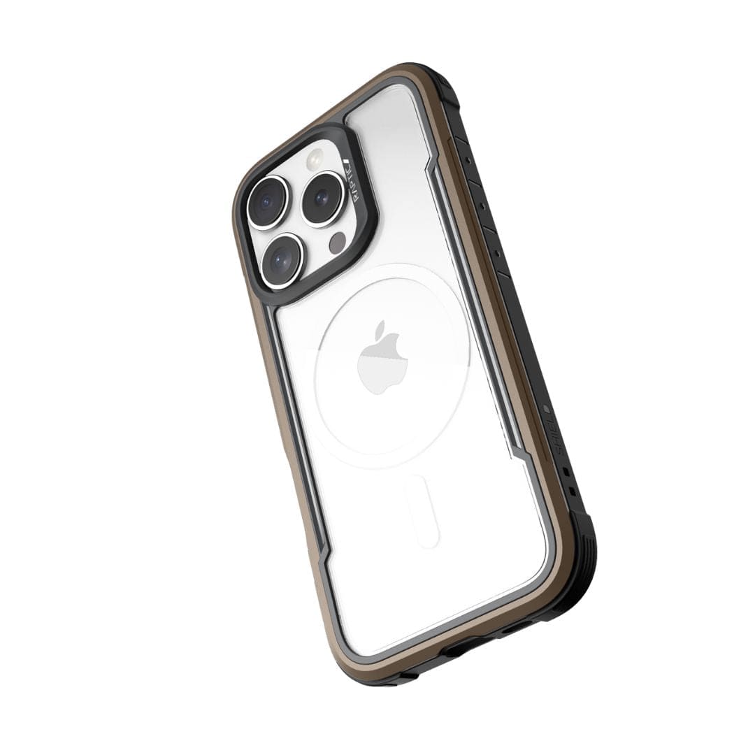 A white iPhone 16 Pro Max with three camera lenses on the back is encased in a Raptic Shield MagSafe Case from Raptic. This rugged, transparent case features black and brown edges, offers 3-metre drop protection, and has precise cutouts for the cameras, flash, and other components. The Apple logo is visible through the transparent back.