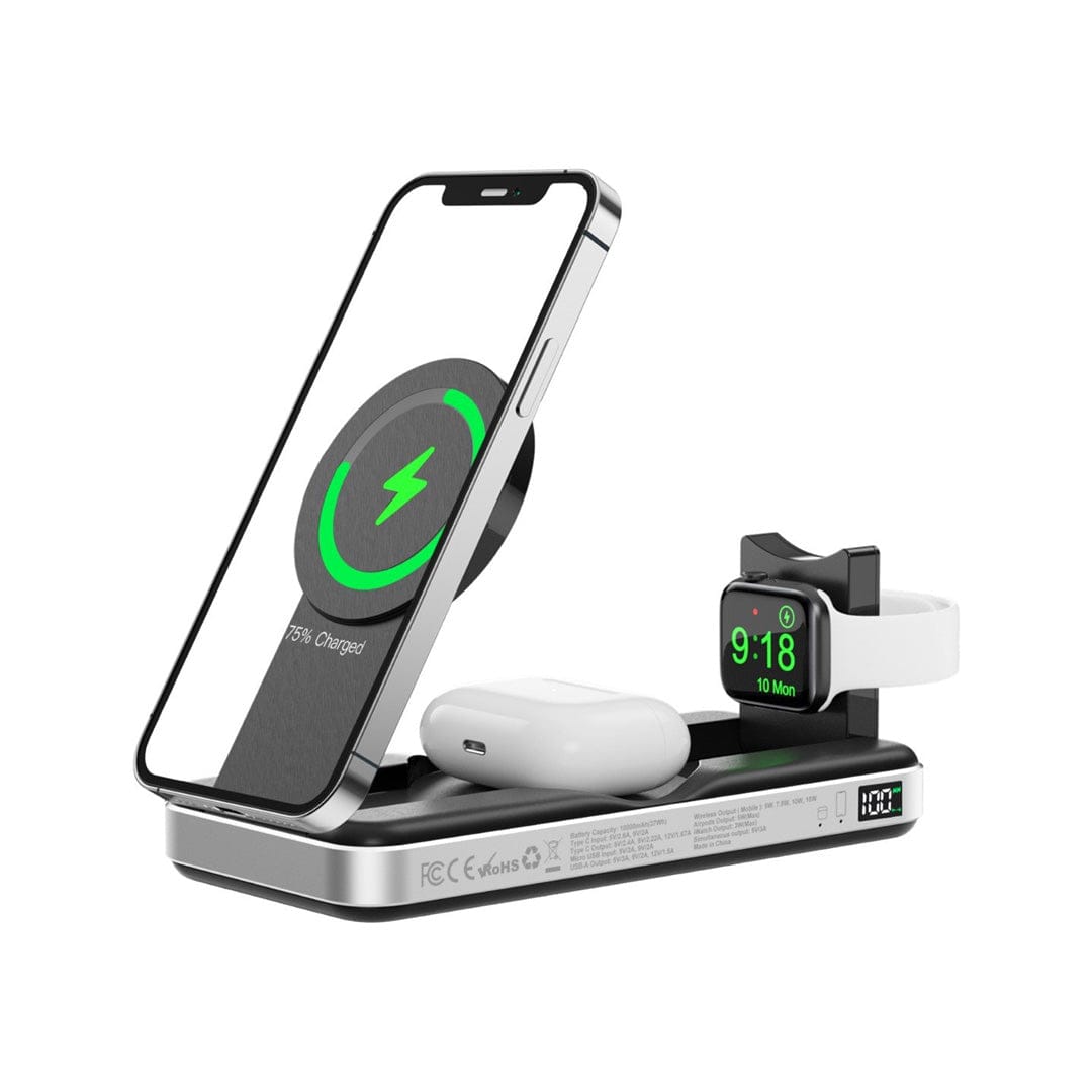 An elegant, travel-friendly Urban PowerBuddy 5in1 Wireless MagSafe Powerbank 2 in use, charging a smartphone, wireless earbuds, and a smartwatch simultaneously. The smartphone's screen displays a green circular charging icon with "75% Charged," and the smartwatch screen shows the time "9:18 Mon.