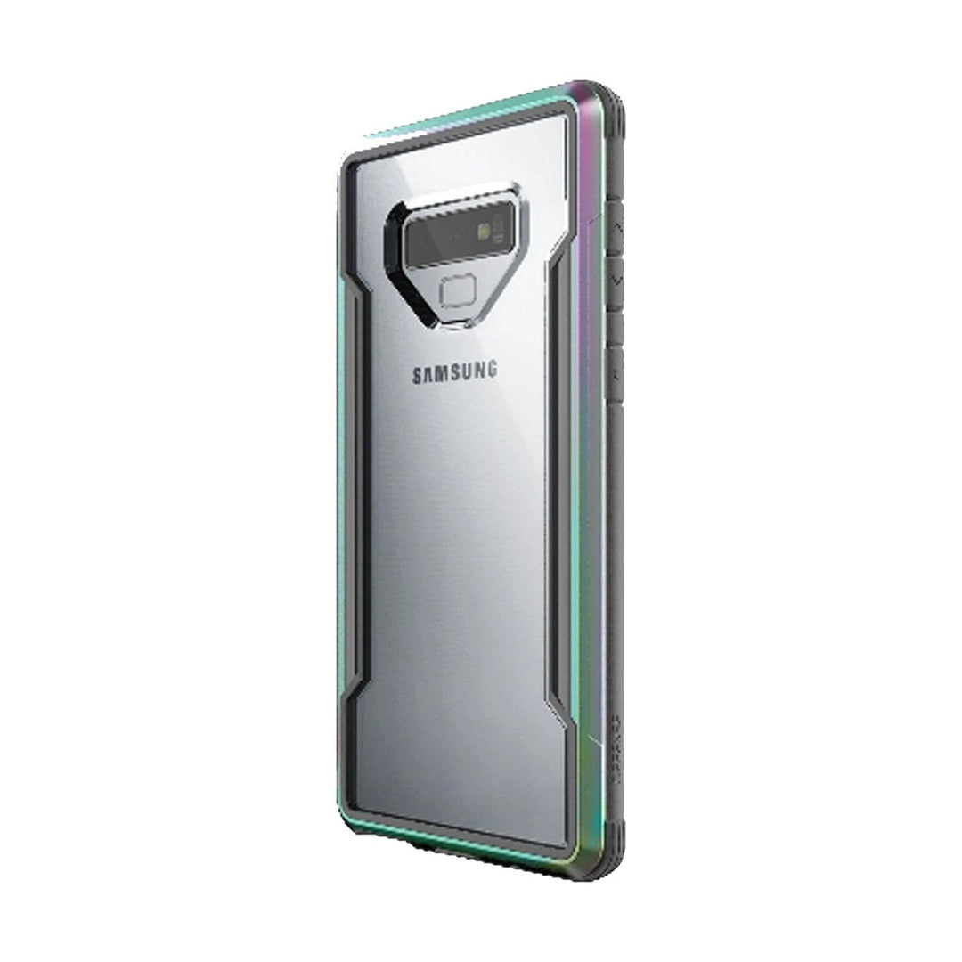 A Samsung Galaxy Note 9 encased in a Raptic X-Doria Defense Shield, a clear, military-grade protective case with an angular design around the camera and fingerprint sensor on the back. The case is also compatible with wireless charging, ensuring both durability and convenience.