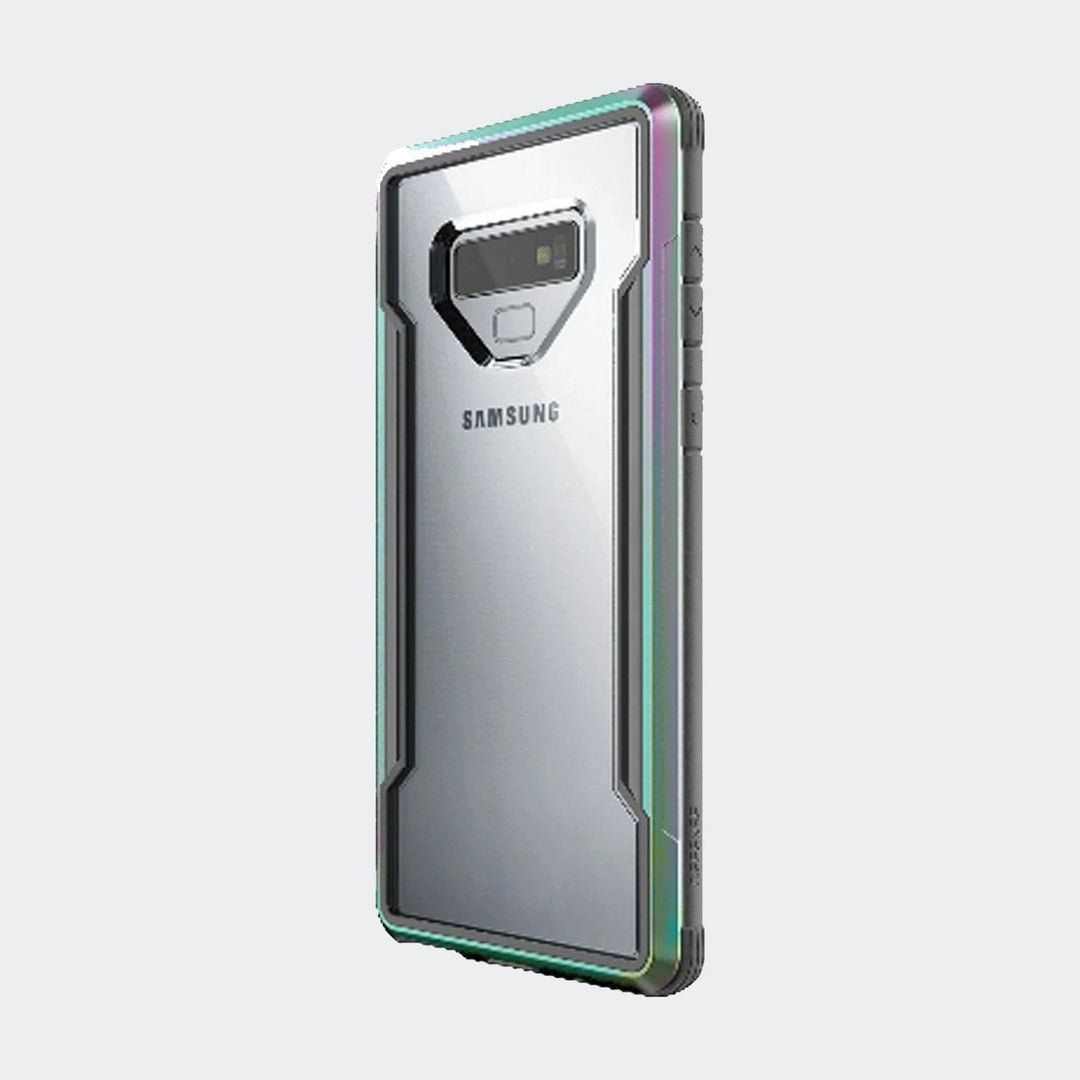 A Raptic X-Doria Defense Shield case for the Samsung Galaxy Note 9 featuring a military-grade clear design that showcases the rear camera, fingerprint sensor, and SAMSUNG logo. This sleek protective case is also wireless charging compatible for your convenience.