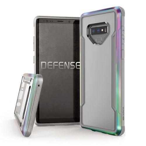 Three smartphones are shown: one with a visible screen displaying the word "DEFENSE," and two others featuring Raptic's military-grade X-Doria Defense Shield cases for the Samsung Galaxy Note 9.